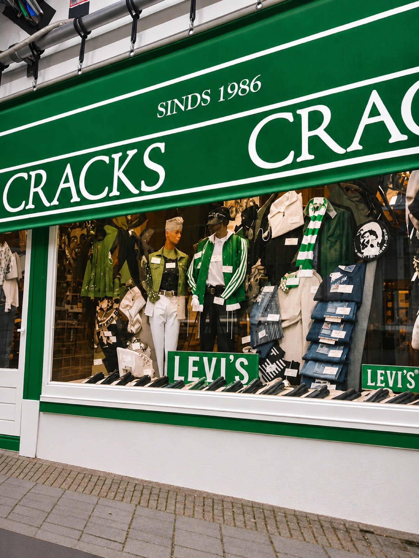 The Cracks shop window with its green awning, reading Sinds 1986 Cracks