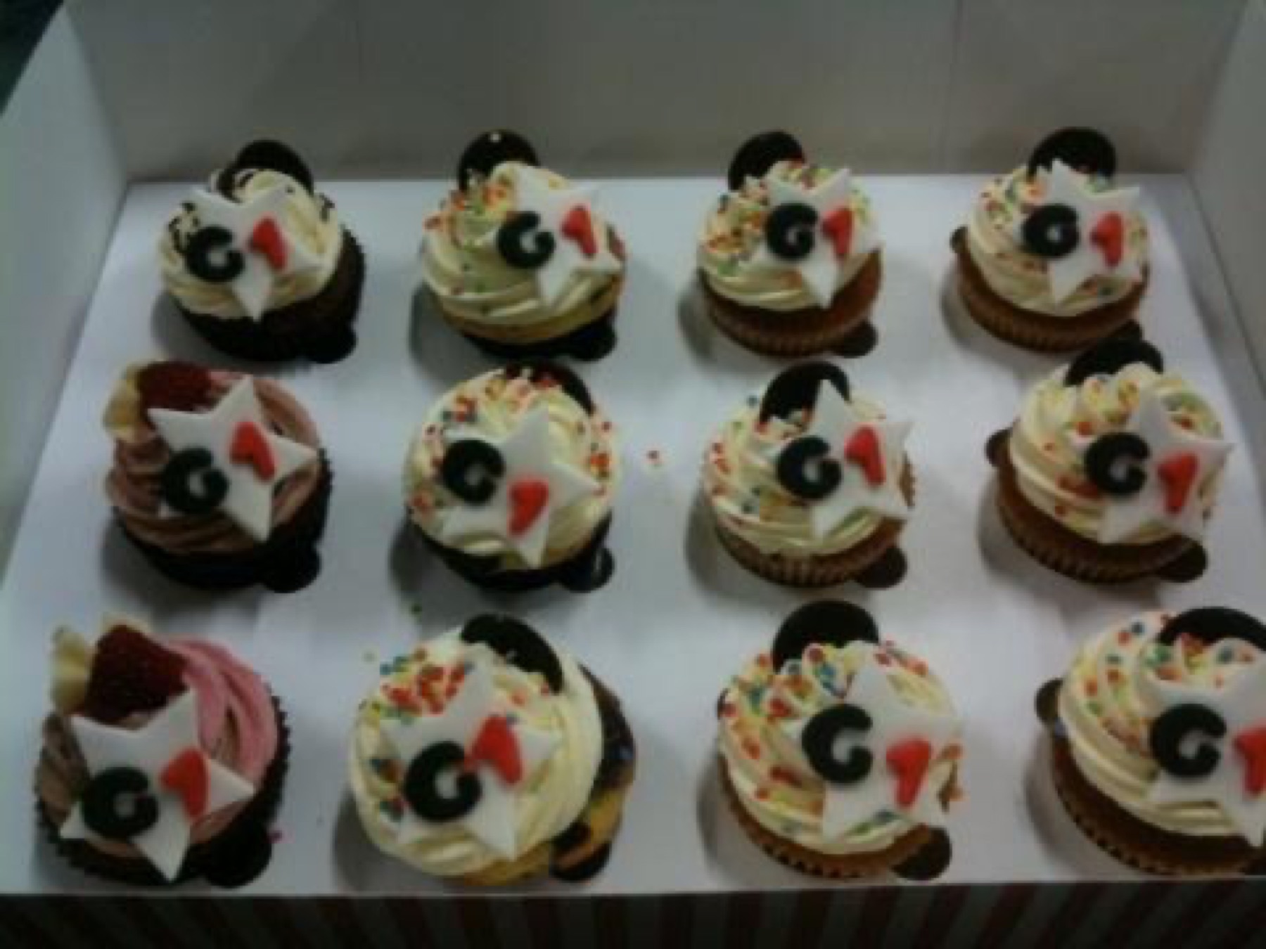 Box of cupcakes decorated with G-Star logos