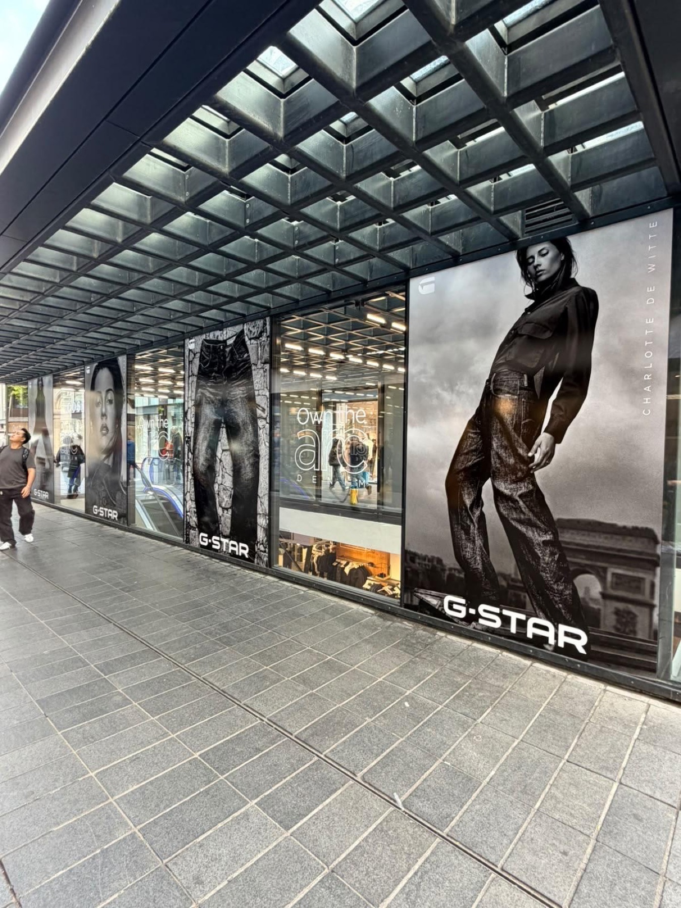 G-Star storefront with Charlotte de Witte campaign posters under the grid canopy